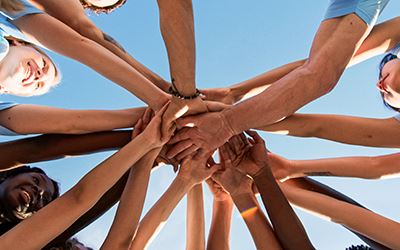 Hands in together links to the Volunteer Opportunities webpage