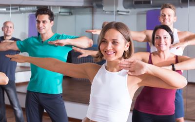 adults in Zumba class links to Fitness Classes webpage